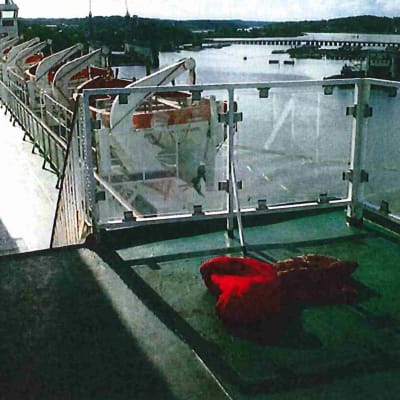 En röd sovsäck på ett fartygsdäck.