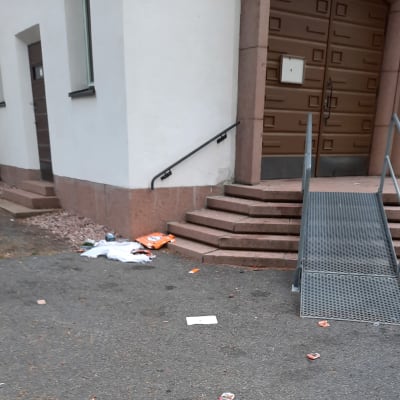 Kirkon portaiden edessä on roskia. Portaiden edessä on invaliuska. 