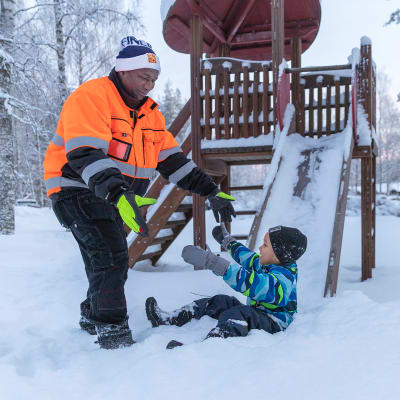 Lamin leikkii lapsensa kanssa lumessa.
