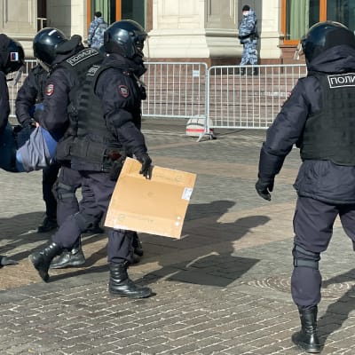 Riot policemen detain a man