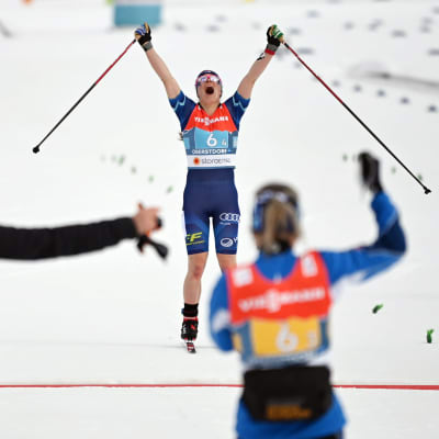 Krista Pärmäkoski firar då hon korsar mållinjen.