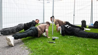 Fyra män göra armhävningar.