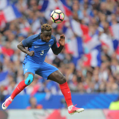 Blåklädde fotbollsspelaren Benjamin Mendy hoppar och nickar bollen.