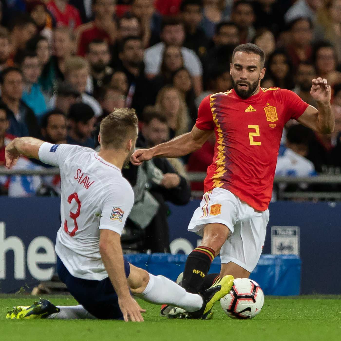 A fight between a player in white and a player in red.