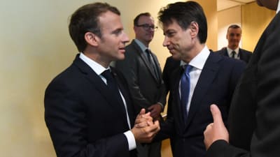 Frankrikes president Macron och Italiens premiärminister Conte skakar hand inför det inofficiella toppmötet i Bryssel söndagen 24.6.2018,