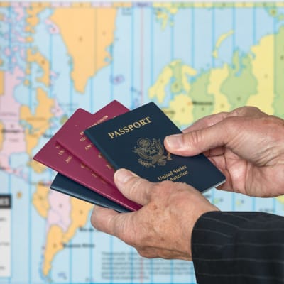 mies pitelee passeja käsissään, passi, usa, kartta