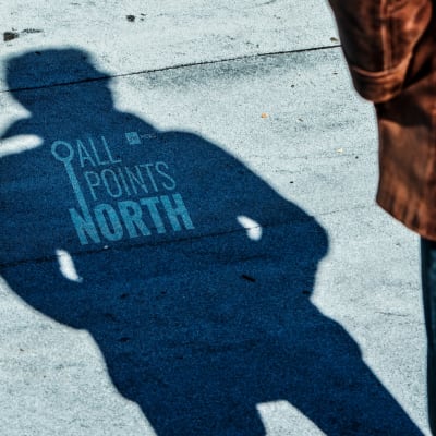 Photo of a man's shadow featuring the APN podcast logo.
