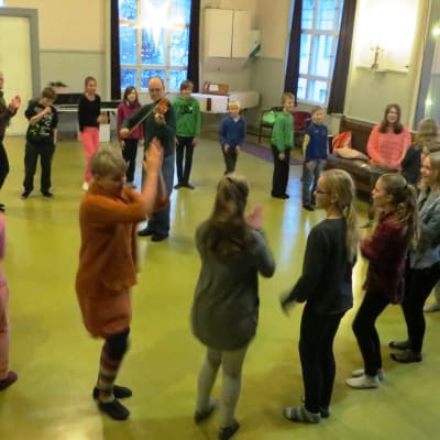 Borgby skolas elever i Sibbo lär sig ringlekar under ledning av Heidi Palmu och spelman Anders Backman