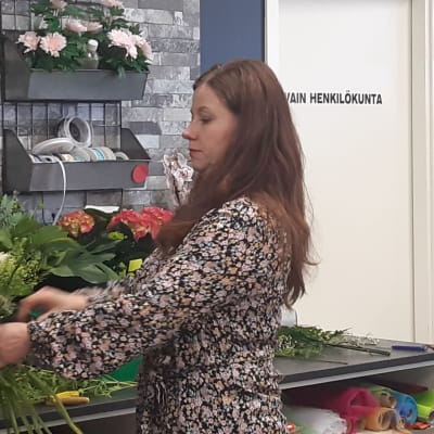 Kemiläisen Linja-Kukan yrittäjä Johanna Åhman sitoo kukkakimppua.