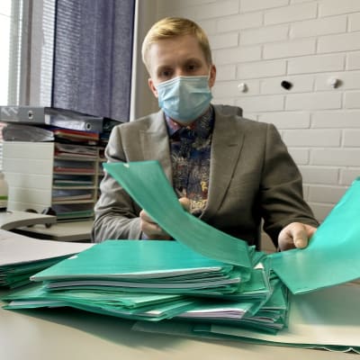 Hallintojohtaja Henri Pätsi selaa Puolangan kunnalle lähetettyjä asiatonta tekstiä sisältäviä asiakirjoja.