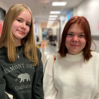 Salpausselän koulun yhdeksäsluokkalaiset Aada Saariko ja Alisa Mansikka seisomassa koulun käytävällä.