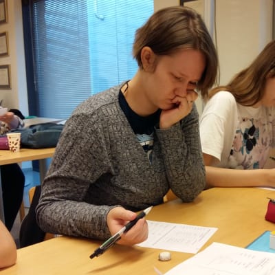Jasmine Öjbro och tre andra utländska kvinnor läser finska på en kurs.