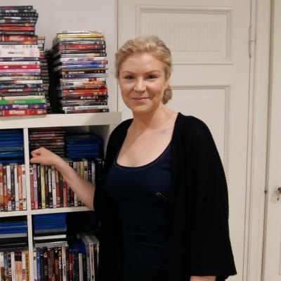 Filmproducenten Leila Lyytikäinen poserar vid en dvd-hylla