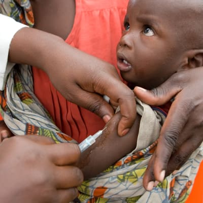 FN-arbetare vaccinerar ett barn mot mässling i Kongo-Kinshasa