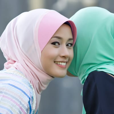 Två muslimska tjejer talar med varandra. 