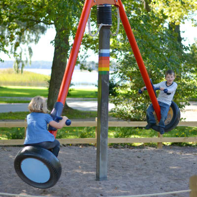 Två barn leker i en lekpark.