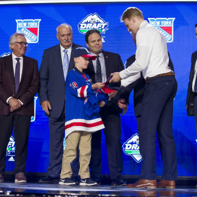 Kaapo Kakko får ta emot Rangerströja och -keps.