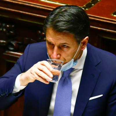  Italiens premiärmMinister Giuseppe Conte tar en klunk vatten 18.1.2021då han talar till underhuset