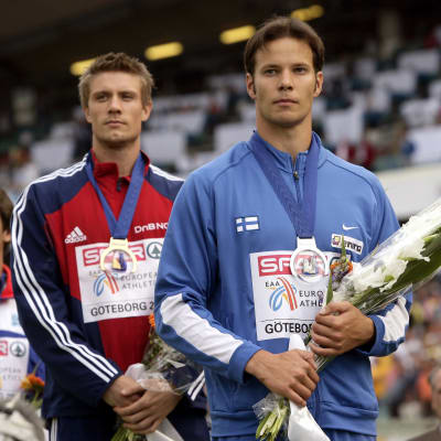 Andreas Thorkildsen och Tero Pitkämäki står på prispallen och blickar snett framåt.
