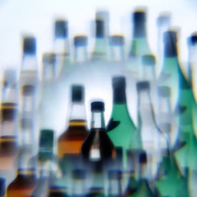 Wine and hard liquor bottles photographed through a multiprism filter