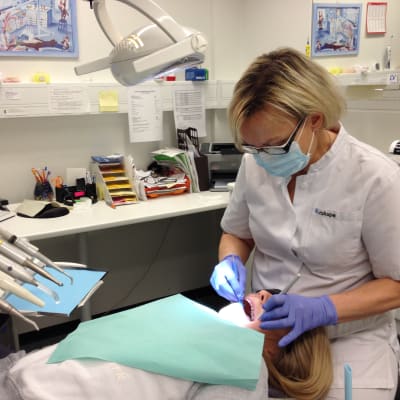 Suuhygienisti tarkastaa tytön hampaiden terveyden