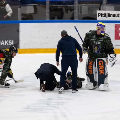 Jukurien Patrik Puistolaa hoidettiin jään pinnassa tiistaina, kun hän loukkaantui Ilveksen Panu Miehon taklauksen seurauksena.