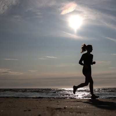 Anonyymi yleiskuva nainen juoksee rannalla