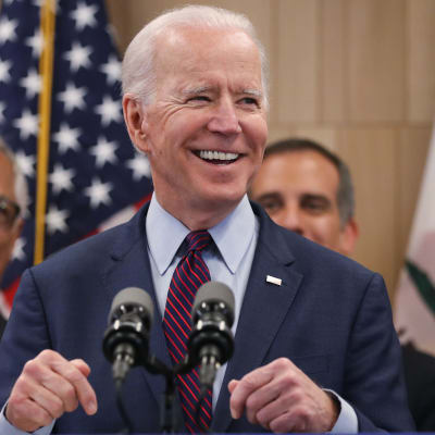 Joe Biden ler mot kameran.