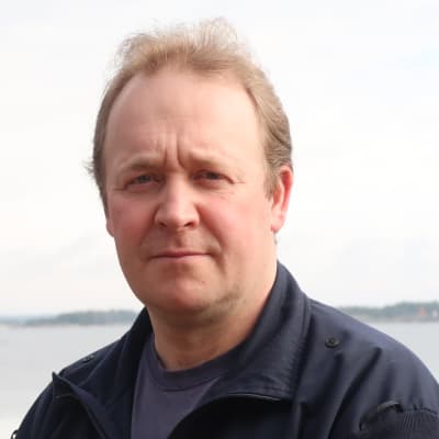 Peter Fihlman i mörk fleece, havet i bakgrunden
