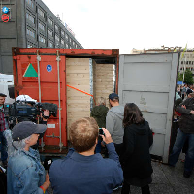 Rakel Liekki, Dan Granqvist och Susani Mahadura går in i containern.