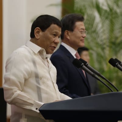 Rodrigo Duterte håller tal i Sydkorea. Bredvid honom Sydkoreas president  Moon Jae-in