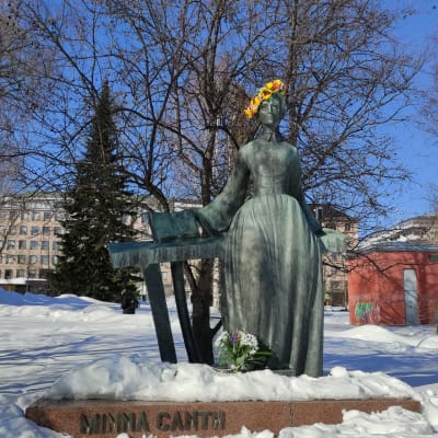 Minna Canthin patsaalla on kukkaseppele päässä Jyväskylässä Kirkkopuistossa.