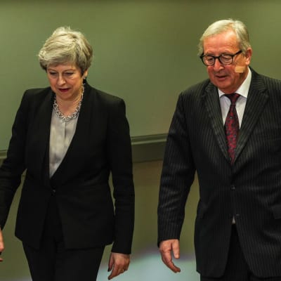 Theresa May och Jean-Claude Juncker går brevid varandra.