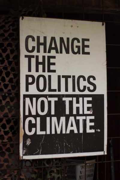 Skylt med texten "Change the politics, not the climate".