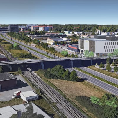 Turun moottoritien alkupäässä on kaksi valkoista rakennusta. Kuvassa näkyy muitakin rakennuksia.