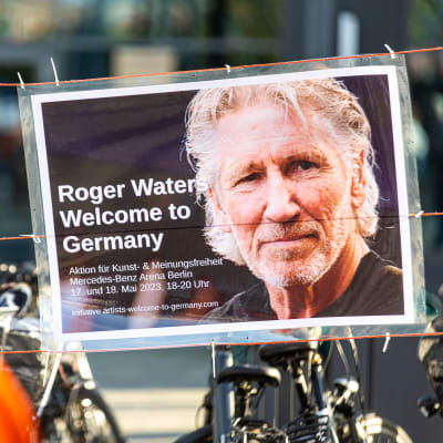 Roger Watersin konserttipaikan ulkopuolella Berliinissä oli runsaasti mielenosoittajia 17. toukokuuta 2023. Kuvassa laminoitu juliste, jossa toivotetaan Roger Waters tervetulleeksi Saksaan.