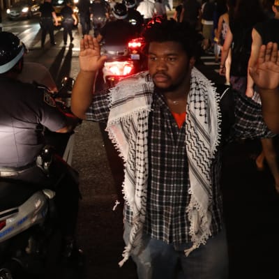 Demonstrant håller upp händerna under fredlig demonstration i New York