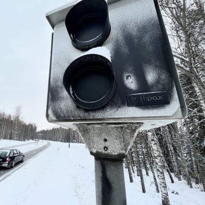 Nopeusvalvontakamera, jota on töhritty mustalla maalilla.