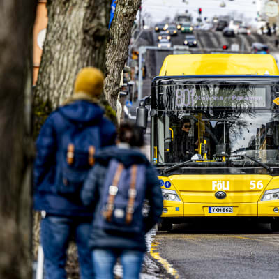 två människor väntar på bussen