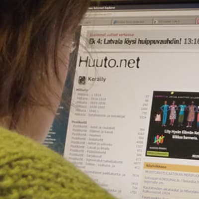 Nainen tutkii Huuto.net-sivustoa.