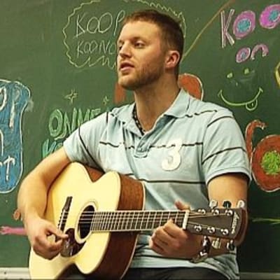 Koop performing at a school.
