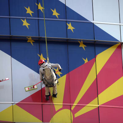 Makedonian pääkaupungissa Skopjessa pestiin lipuin koristettuja ikkunoita helmikuussa.