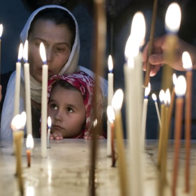 A child with her mother light candles in a chapel in the Church of the Holy Sepulchre in Jerusalem's Old City on Easter Sunday, 20 April 2014. The church is the accepted site of Jesus Christ's crucifixion, burial and resurrection.
