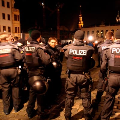 Poliisi valmistautuu äärioikeistolaisen Pegidan mielenosoitukseen pimenevässä illassa Saksan Dresdenissä