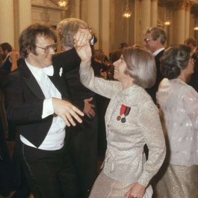 Man i frack och kvinna i festdräkt dansar