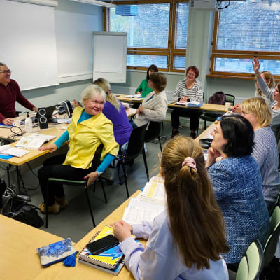 Ukrainare deltar i en lektion i ett klassrum.