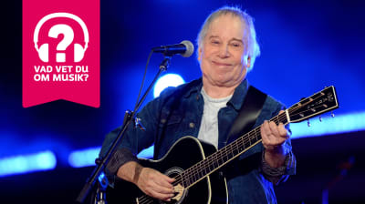 Paul Simon ler och spelar akustisk gitarr.