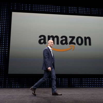Jeff Bezos framför en skylt med bolagsnamnet Amazon.