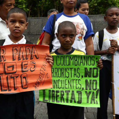 Två barn deltar i en demonstration för mänskliga rättigheter utanför ett FN-kontor i Caracas