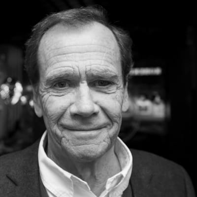 Svartvit porträttbild på Robert Paulig som ler rakt in i kameran.